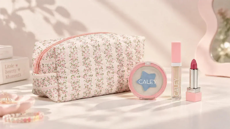 Caley Cosmetics makeup set with floral pouch, cream makeup, lip gloss, and lipstick products.