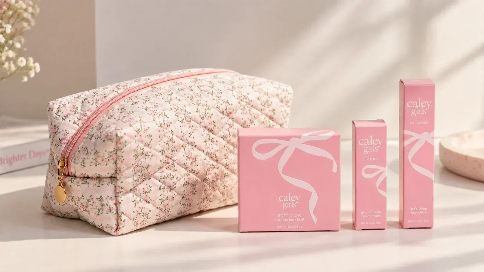 Caley Cosmetics Color Play Repeat Natural Makeup Kit for Girls with pink beauty products and floral makeup pouch.
