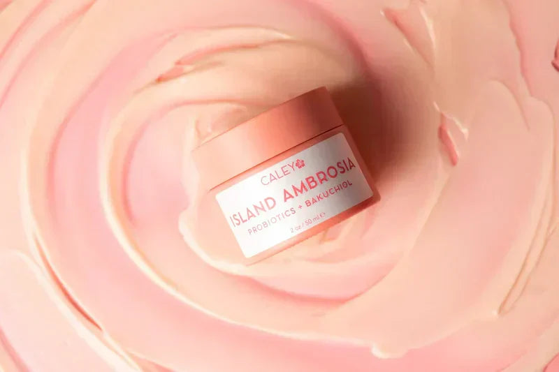 Caley Cosmetics Island Ambrosia bakuchiol moisturizer with probiotic skincare formula shown in a soft pink swirl for acne-prone skin.