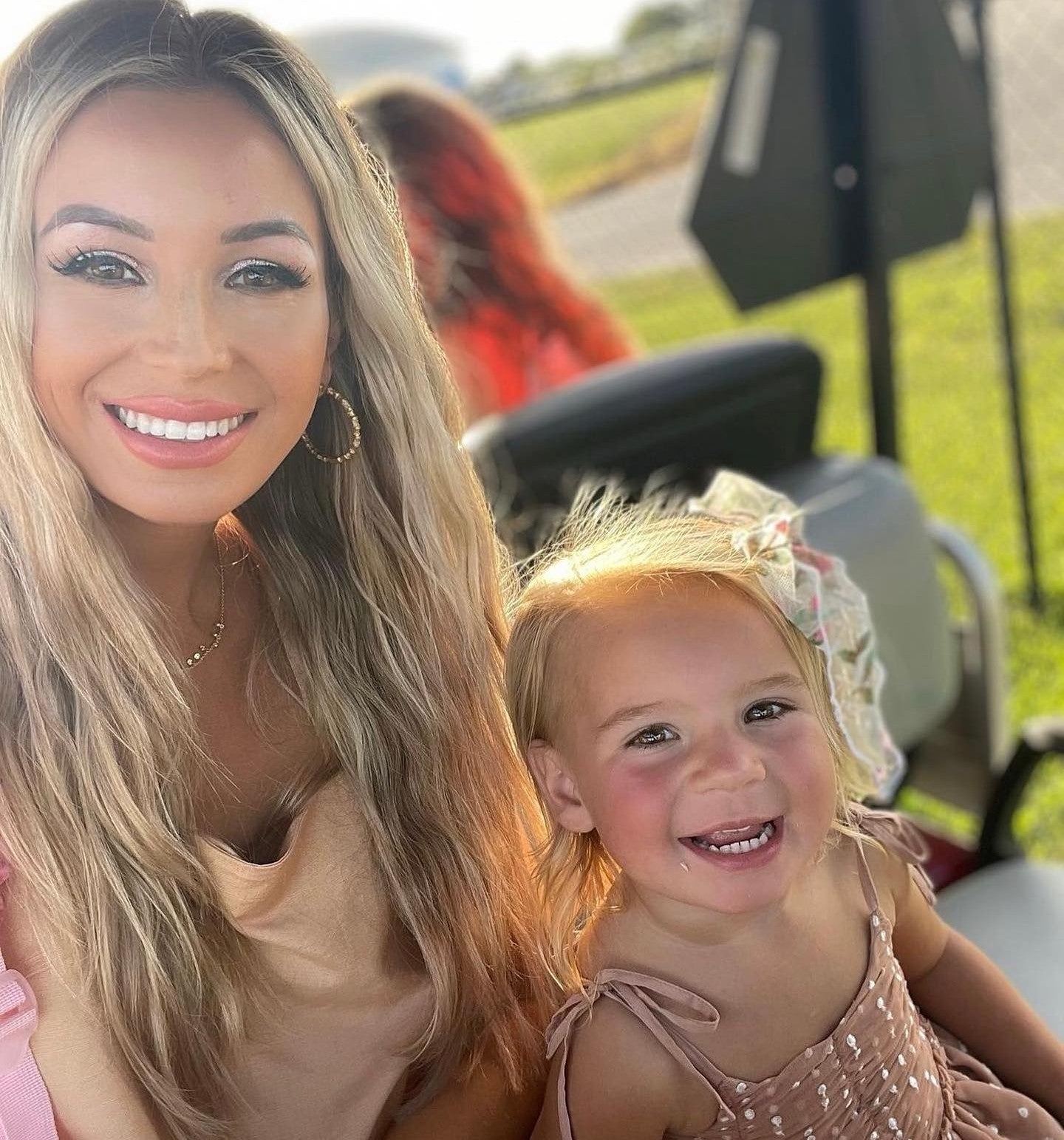 Smiling mom and child enjoying a sunny day, showcasing gentle kid-friendly makeup inspired by Caley Cosmetics.