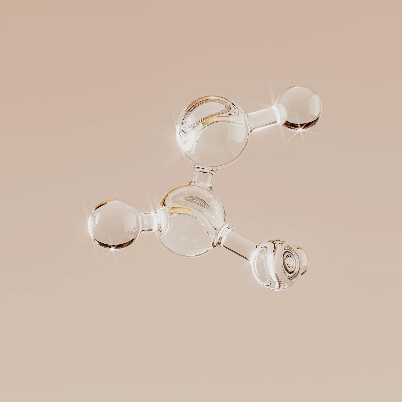 Clear glass molecular model on a beige background