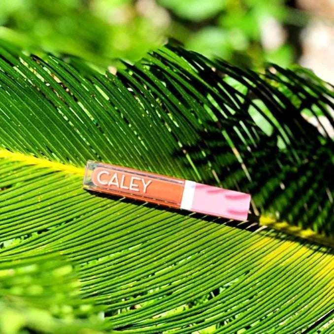Enhance Your Look with Beachy Kiss Natural Lip Oil Lip Gloss, a Probiotic Makeup by Caley Cosmetics - Perfect for a Radiant Beachy Glow!