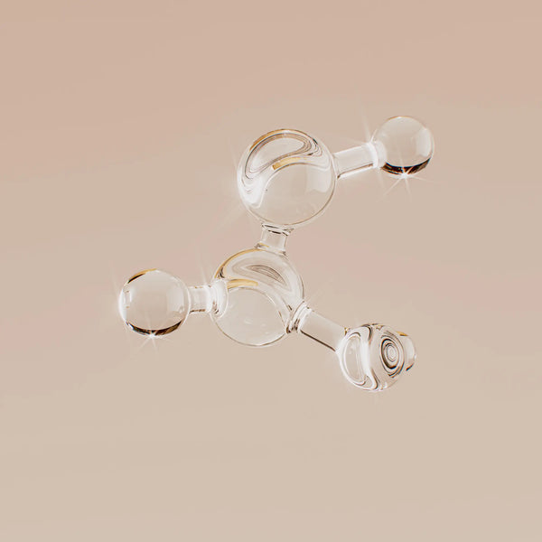 Clear glass molecular model on a beige background