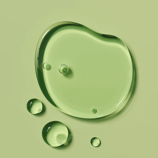 Green liquid droplets on a green background